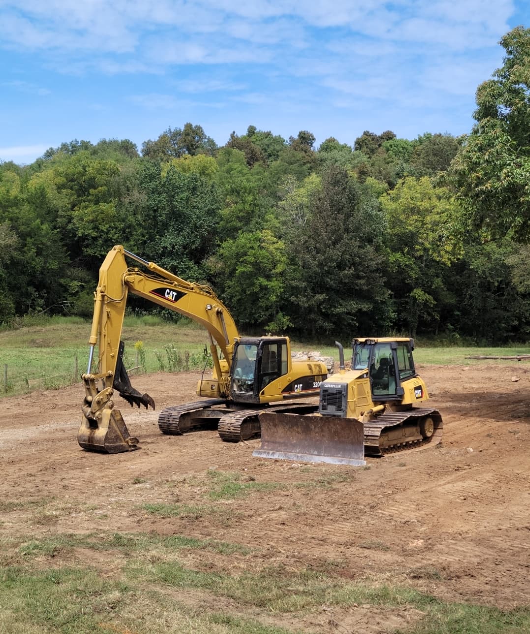 Excavator and bulldozer on a cleared site