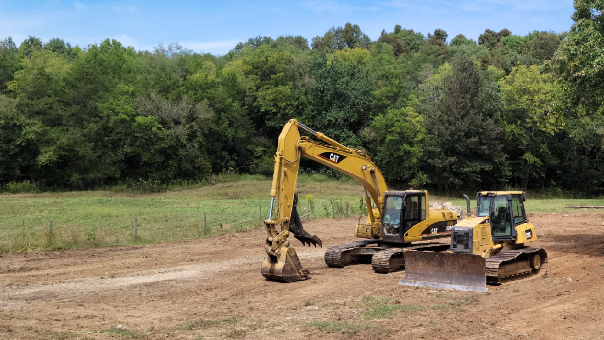 Equipment clearing a field for site preparation